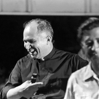 Priest shares humor with Cesar at 1973 Coachella Rally